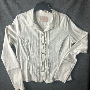 Free People white ruffle button up blouse with boho vibe. Textures detail cufff